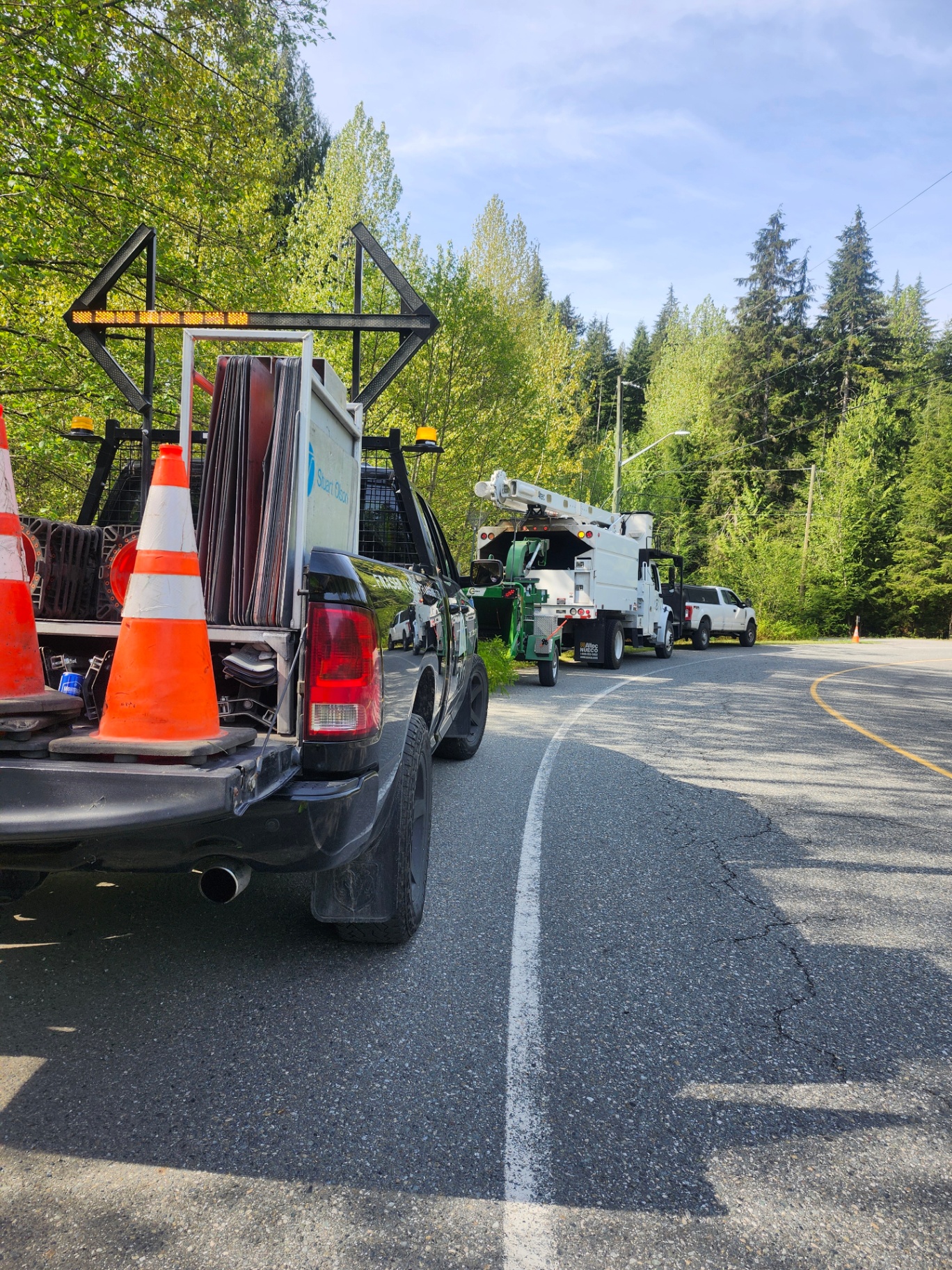 FVF truck parked along forested road during utility work